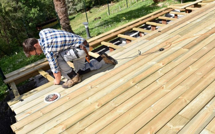 Carpenter building wooden deck 129229439