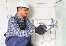 indian plumber installing water equipment meter filter pressure reducer